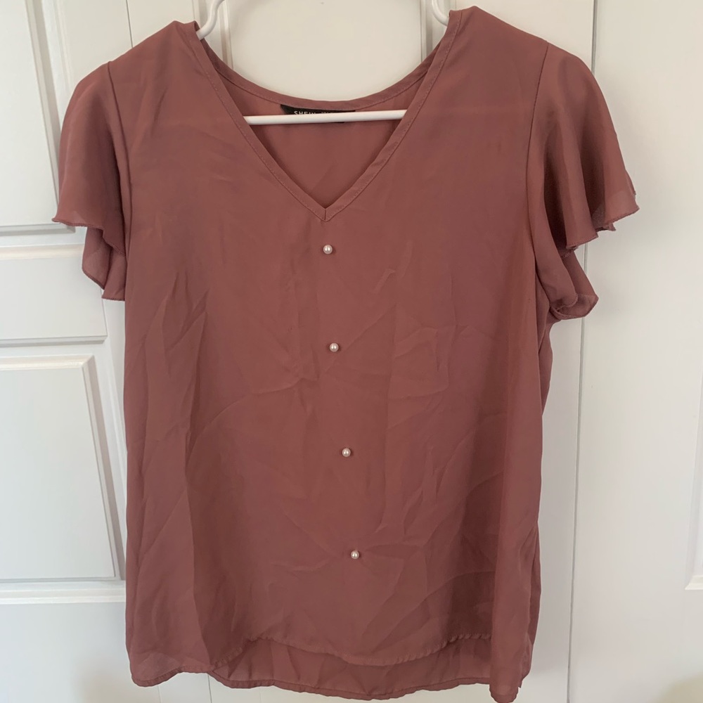 Pink blouse with pearl buttons